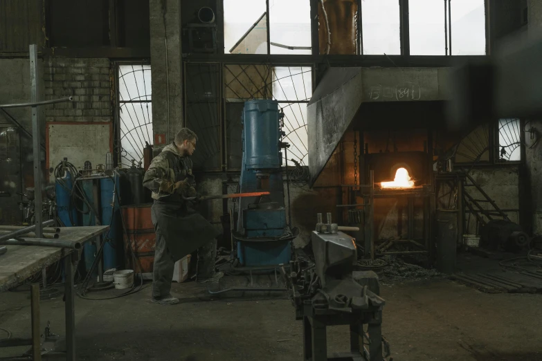 a group of people working in a factory, by Attila Meszlenyi, pexels contest winner, arbeitsrat für kunst, cast iron material, by emmanuel lubezki, 35mm —w 1920 —h 1080, the god of the forge