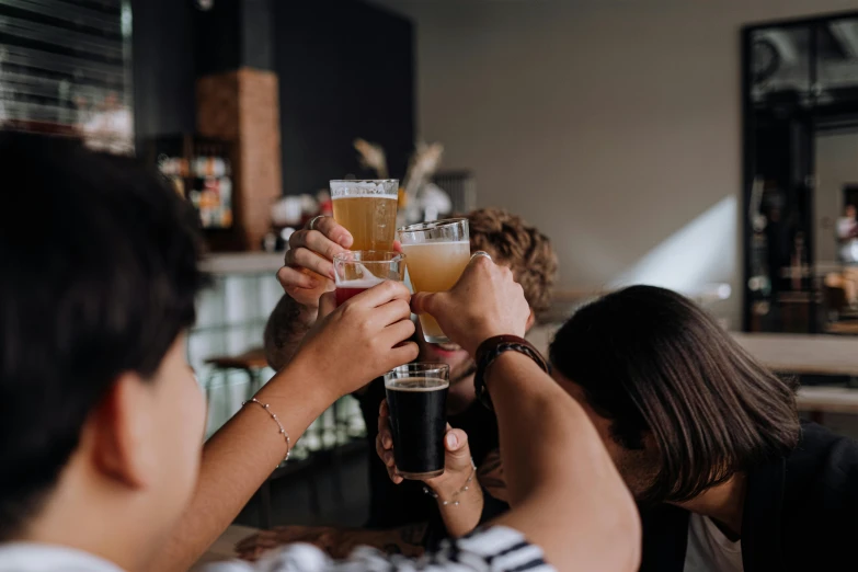 a group of people clinking glasses of beer, pexels contest winner, aussie baristas, mead, thumbnail, lesbians