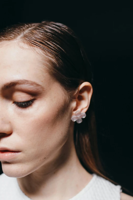 a woman holding a cell phone to her ear, an album cover, inspired by Elsa Bleda, hyperrealism, opal petals, showstudio, earrings, close - up photograph