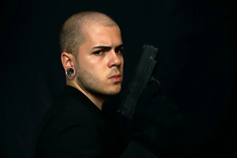 a man with a gun in his hand, a character portrait, inspired by Carlo Mense, pexels contest winner, buzz cut hair, professional photo-n 3, headshot profile picture, artemixel