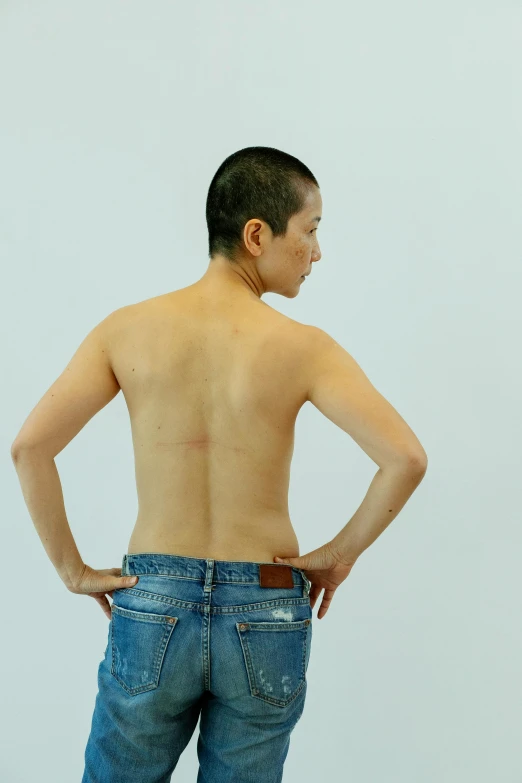 a man standing with his back to the camera, inspired by Zhang Kechun, battle scars across body, non binary model, 2010s, shinichi fukuda