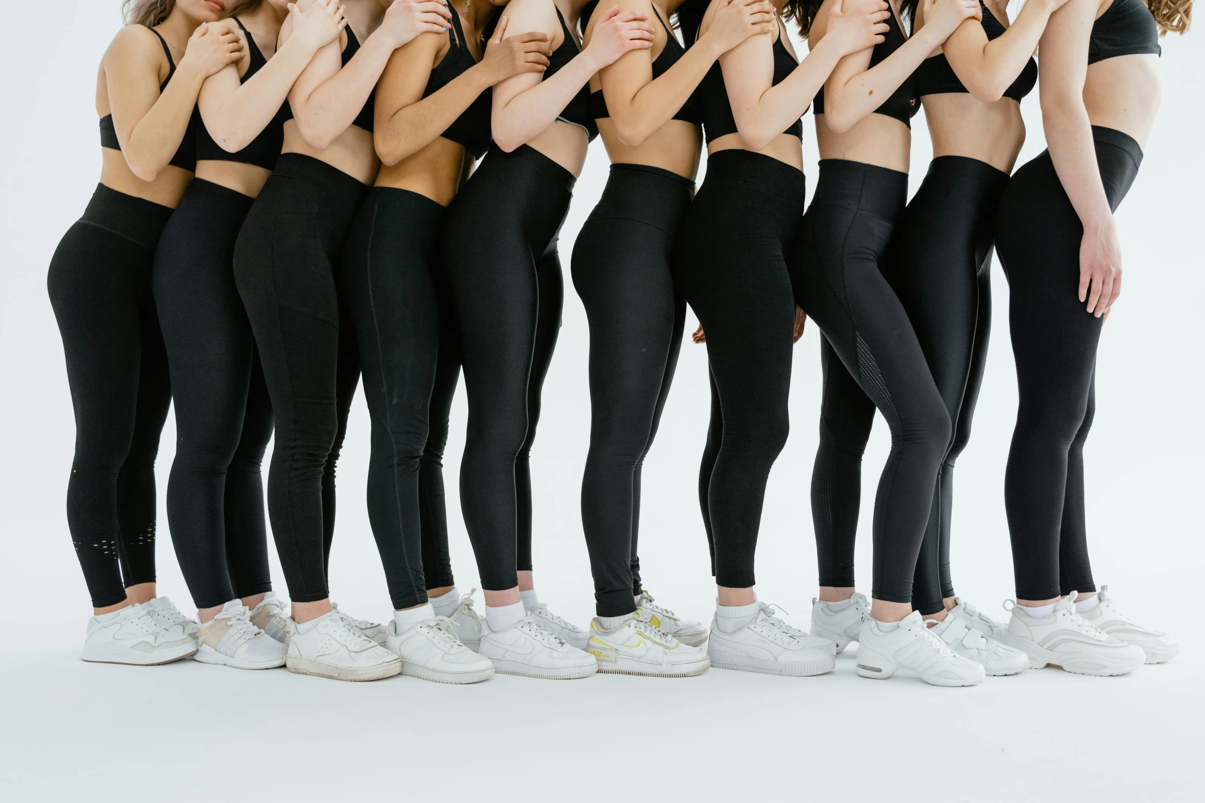 a group of women standing next to each other, inspired by Vanessa Beecroft, trending on pexels, antipodeans, jet black leggins, profile image, 6 pack, lightweight