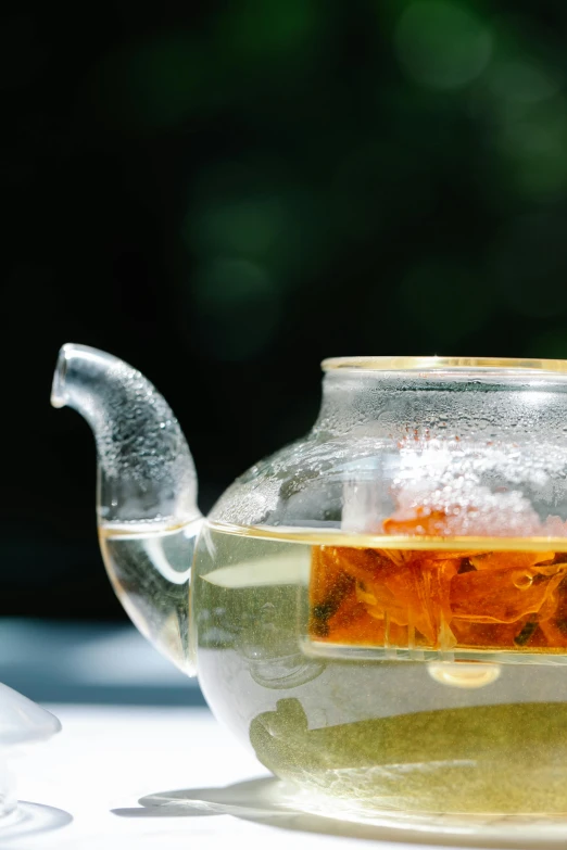 a glass teapot sitting on top of a white plate, inspired by Ma Yuan, unsplash, summer setting, slide show, drink, molten