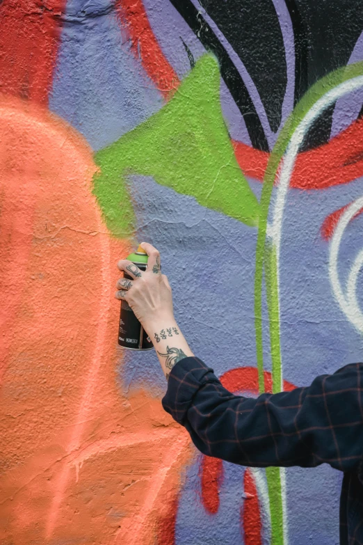 a man spraying graffiti on a wall with a spray can, by artist, pexels contest winner, molotow premium color palette, matte fresco, multicolored, center of image