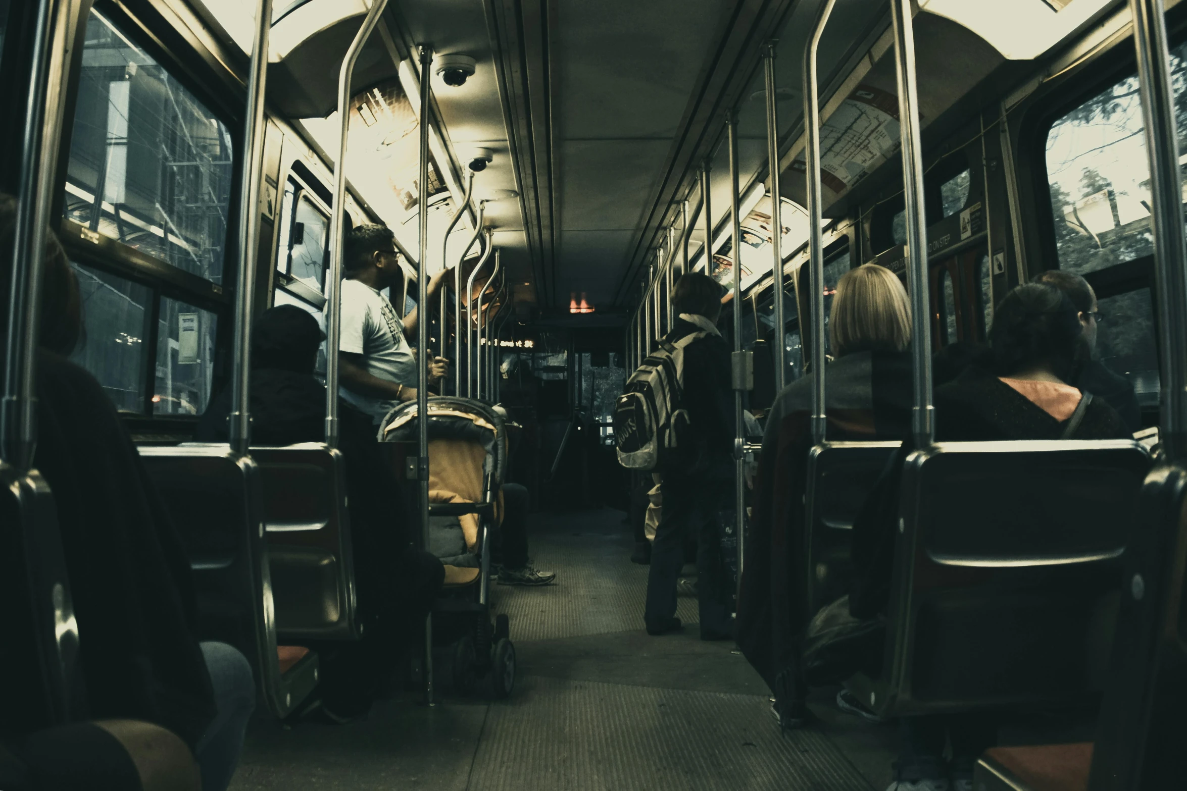a bus filled with lots of people sitting next to each other, a picture, by Lucia Peka, pexels contest winner, dark hallways, subway, thumbnail, vintage color