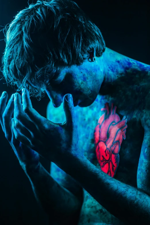 a man with a tattoo on his chest, an album cover, inspired by Elsa Bleda, pexels contest winner, art photography, glowing blue veins, bo burnham, flaming heart, psychedelic colorization