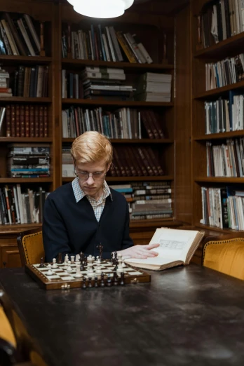 a man playing a game of chess in a library, an album cover, inspired by Simon Marmion, unsplash, academic art, intense albino, looking smart, ignant, a blond