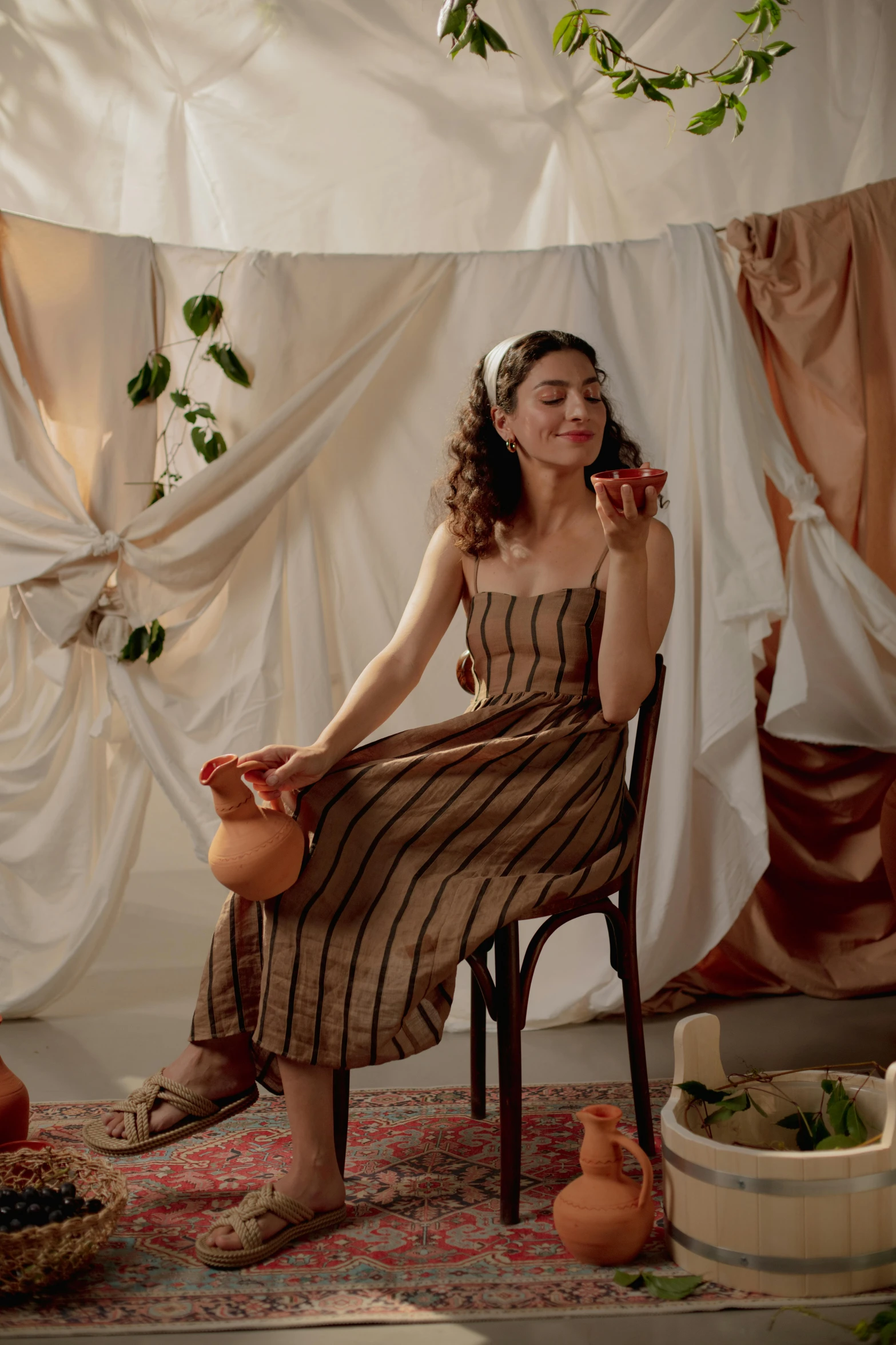 a woman sitting in a chair holding an apple, trending on pexels, renaissance, soft silk dress, brown tones, stripes, celebration