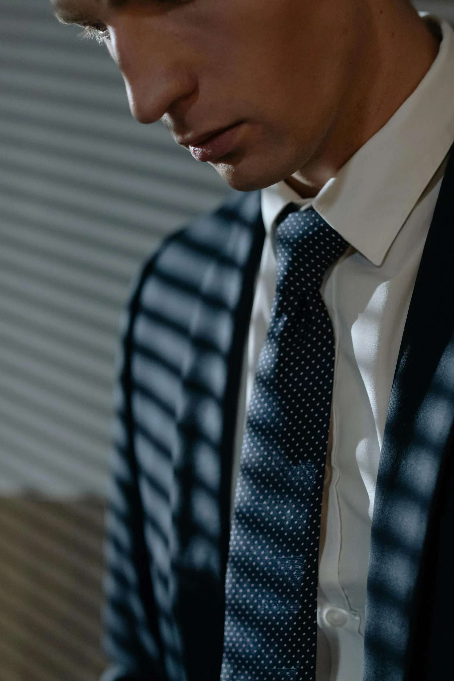 a close up of a person wearing a suit and tie, unsplash, avatar image, office clothes, dark blue and white robes, indoor picture