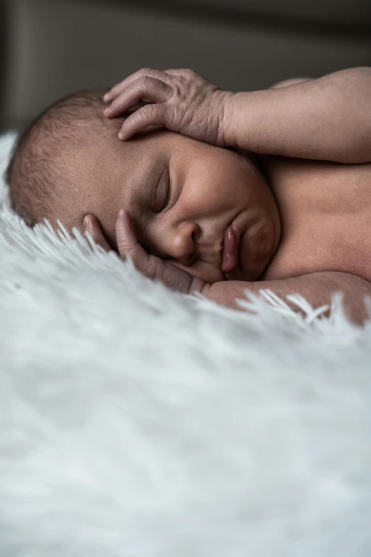 a baby sleeping on a fluffy white blanket, by Ruth Simpson, pexels contest winner, symbolism, head shoot, high textured, ignant, little brother