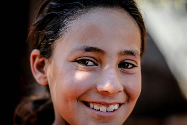 a close up of a person with a smile on her face, by Daniel Lieske, pexels contest winner, hurufiyya, from egypt, teenager girl, slide show, the face of god