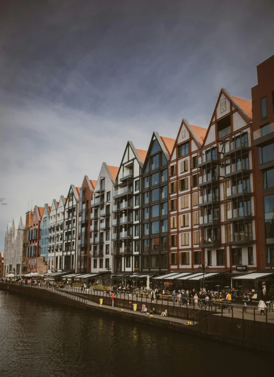 a row of buildings next to a body of water, by Jan Tengnagel, pexels contest winner, modernism, dutch style, lower saxony, profile image, square