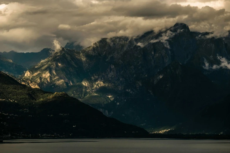 a large body of water with mountains in the background, by Tobias Stimmer, pexels contest winner, romanticism, chiaoscuro, boka, conde nast traveler photo, brown