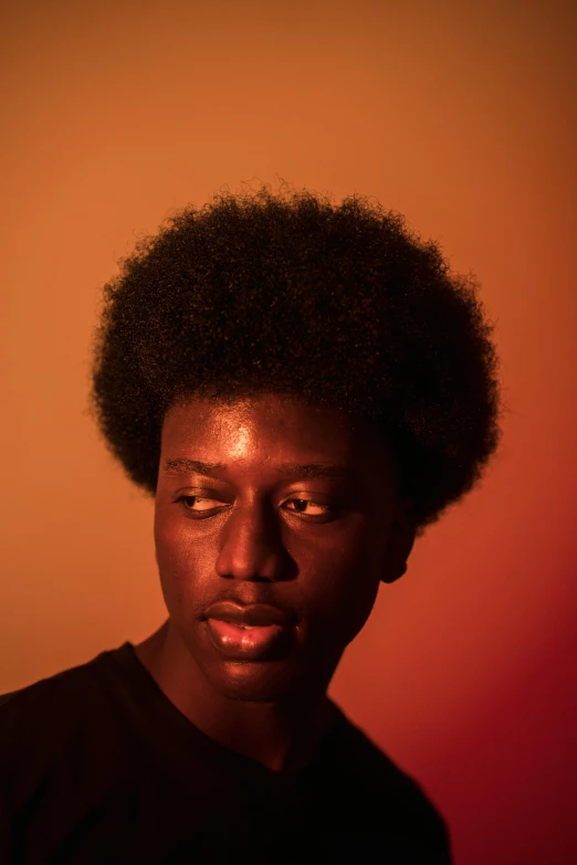 a close up of a person with an afro, by Nathalie Rattner, pexels contest winner, portrait of young man, soft luminescent glow, short black hair with gel, portrait of tall