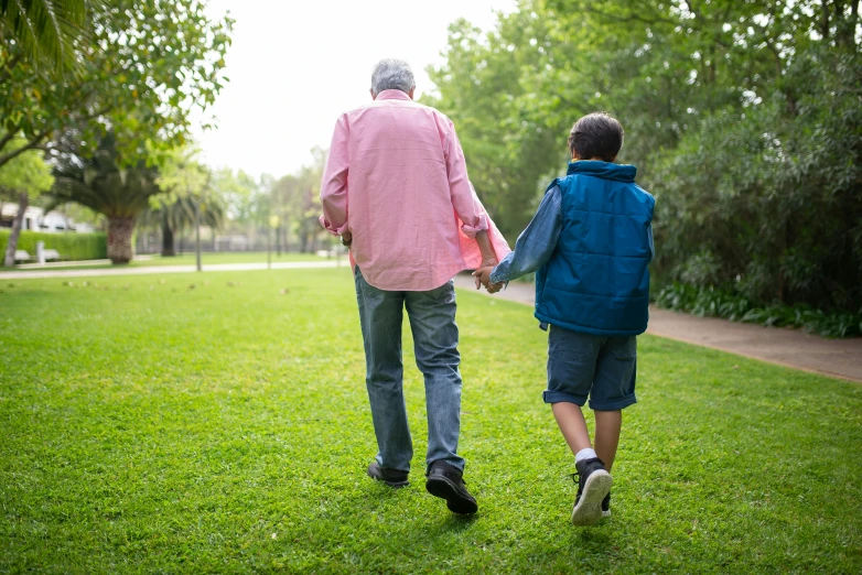 an older man and a young boy walking in a park, by Julian Allen, shutterstock, instagram post, a green, casual game, rip