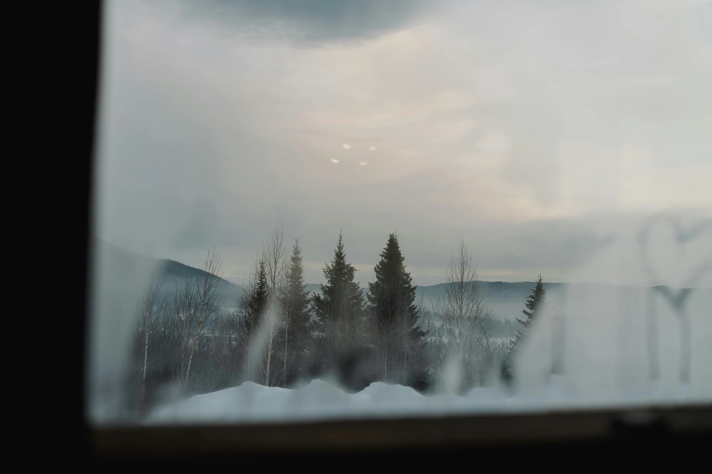 a view of the mountains through a window, inspired by Gregory Crewdson, pexels contest winner, lapland, winter mist around her, landscape from a car window, 🌲🌌