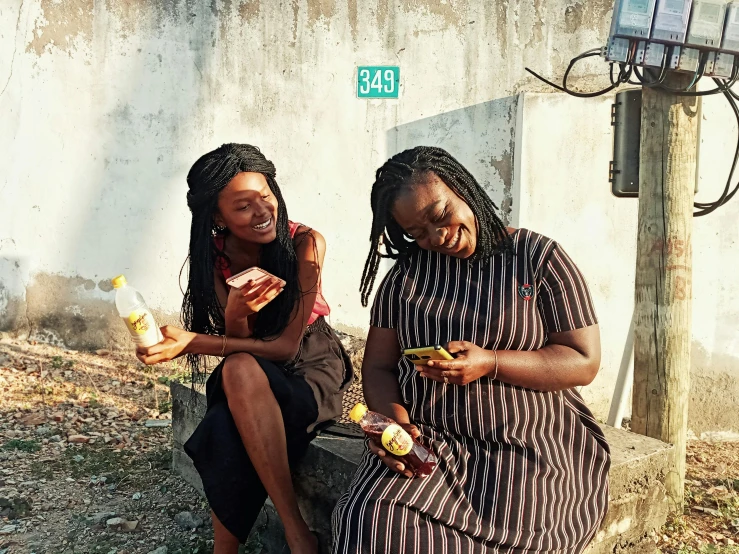 two women sitting next to each other eating food, by Daniel Lieske, pexels contest winner, in style of nadine ijewere, high school girls, neighborhood, artisanal art