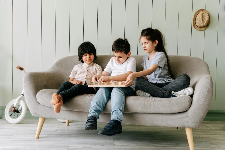 a couple of kids sitting on top of a couch, pexels, interactive art, game board, threes, instagram picture, enes dirig