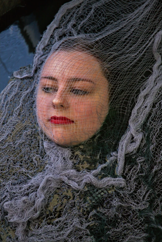 a close up of a woman wearing a veil, an album cover, inspired by Sofonisba Anguissola, net art, artificial spider web, lynn skordal, looking sad, funeral veil