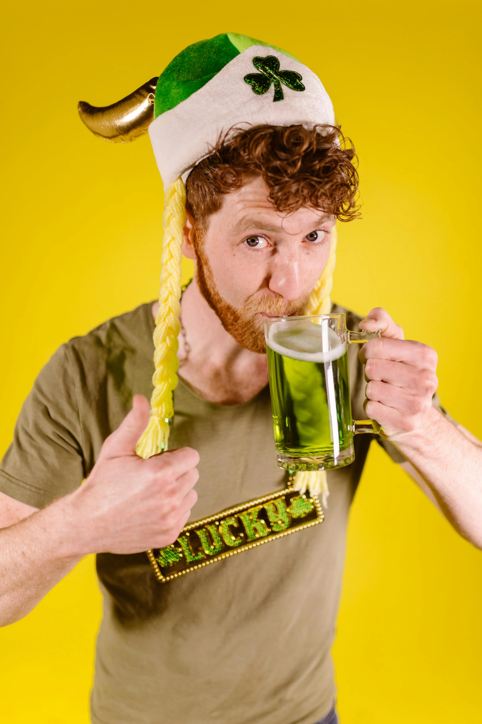 a man wearing a hat and holding a glass of beer, inspired by Dicky Doyle, renaissance, green and yellow, elf ears, shaggy, press photos