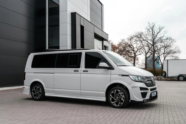 a white van parked in front of a building, a portrait, unsplash, bauhaus, detailed alloy wheels, extremely polished, titanium white, hannover