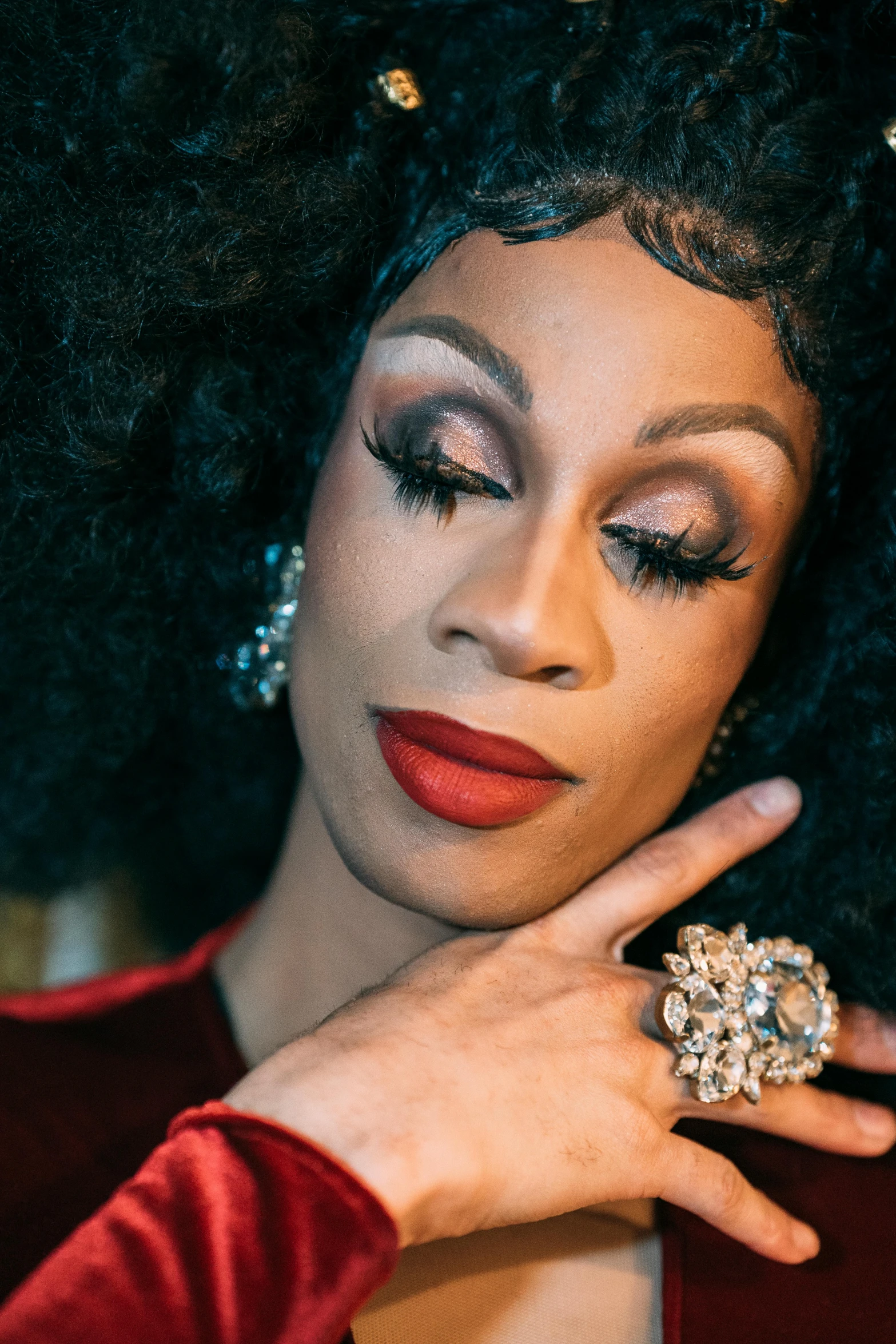 a close up of a woman with a ring on her finger, an album cover, by Winona Nelson, renaissance, ru paul\'s drag race, looking away from camera, ebony, slide show