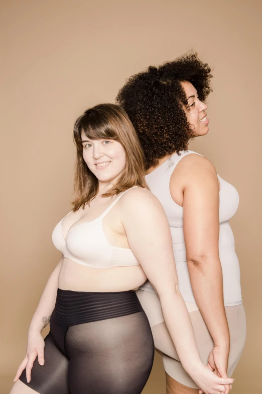 a couple of women standing next to each other, wearing bra, expansive grand scale, profile image