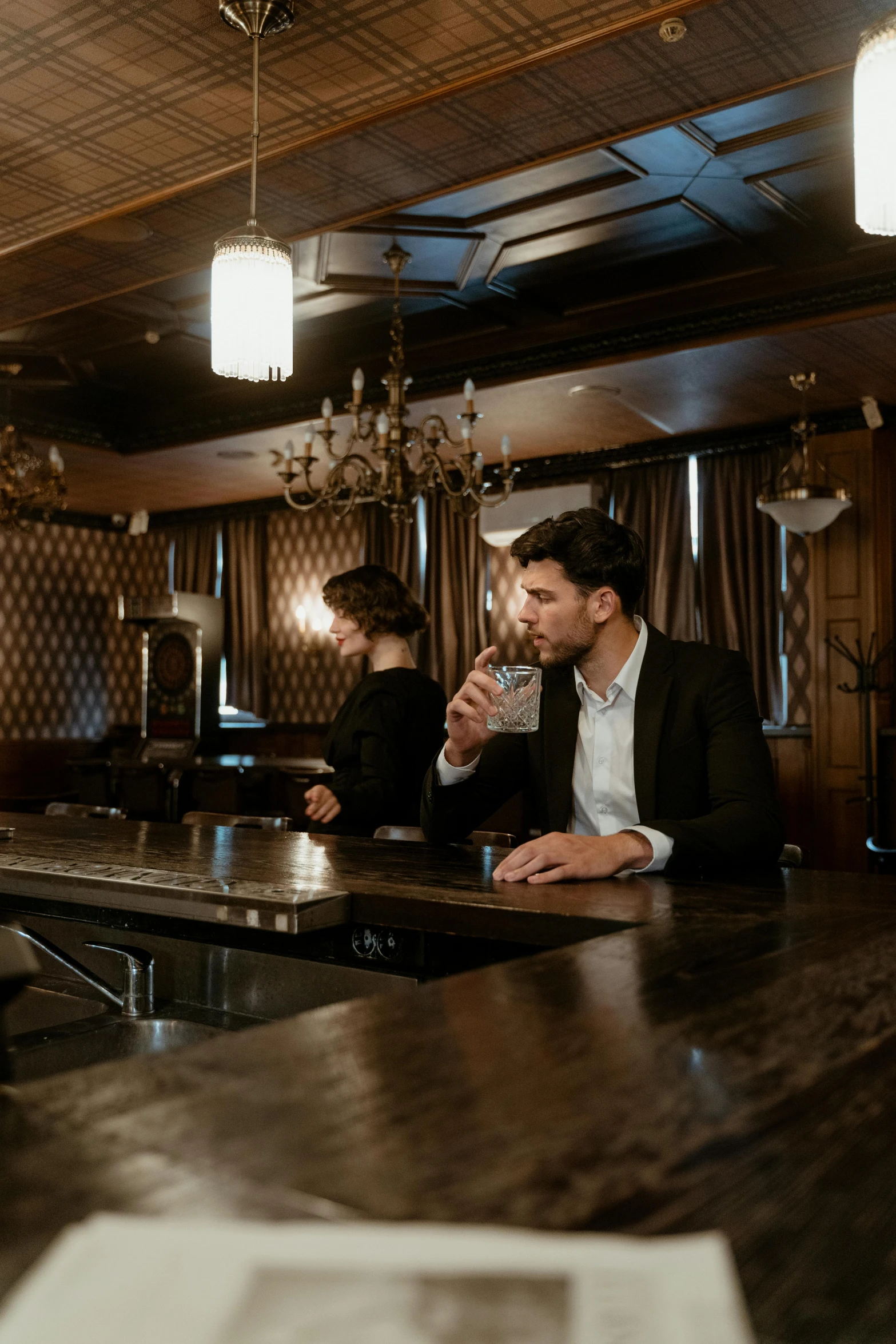 a man sitting at a bar drinking a glass of wine, gentleman's club lounge, two buddies sitting in a room, a handsome