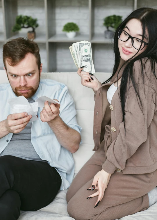 a man and a woman sitting on a couch holding money, trending on reddit, instagram post, concerned, card game, high quality photo