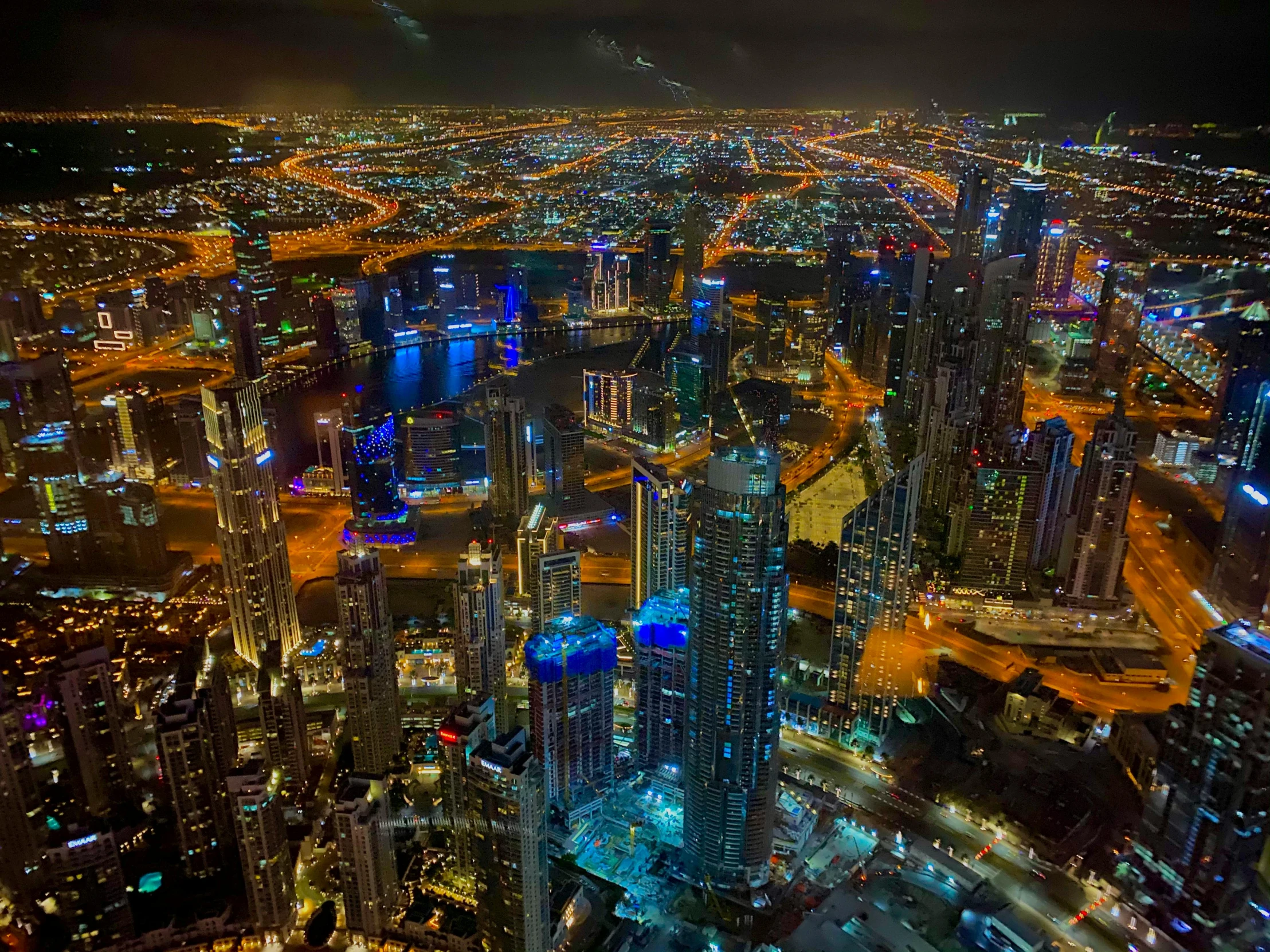 an aerial view of a city at night, pexels contest winner, sheikh mohammed ruler of dubai, hyperdetailed colourful, dramatic”, dramatic ”