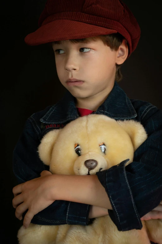 a young boy holding a teddy bear in his arms, an album cover, by Alison Geissler, pexels, cowboy portrait male, serious lighting, kid a, he has a red hat