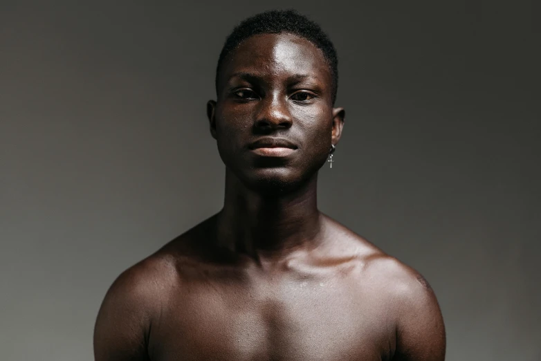 a man with no shirt on posing for a picture, trending on pexels, hyperrealism, brown skin. light makeup, clean - shaven, ( ( dark skin ) ), aged 2 5