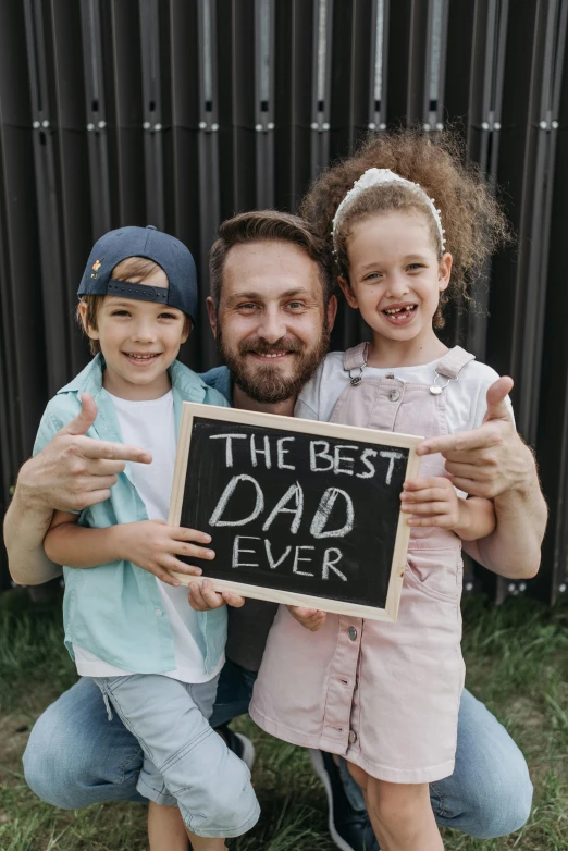 a man and two children holding a sign that says the best dad ever, pexels contest winner, chalkboard, instagram post, te pae, rectangle