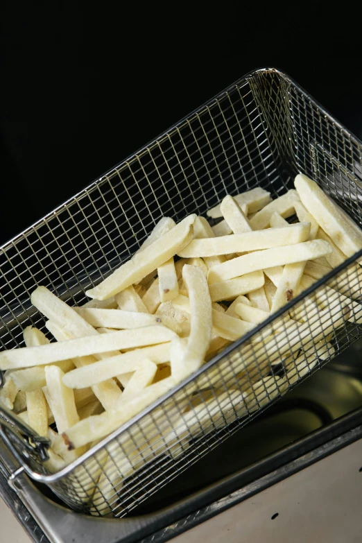 a basket of french fries sitting on top of a counter, f 1, tungsten, up close, various sizes