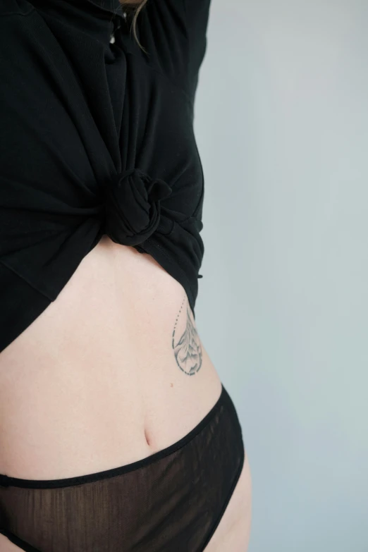 a woman with a tattoo on her stomach, inspired by Elsa Bleda, pexels contest winner, figuration libre, full view blank background, low quality photo, temporary tattoo, an anthropomorphic stomach