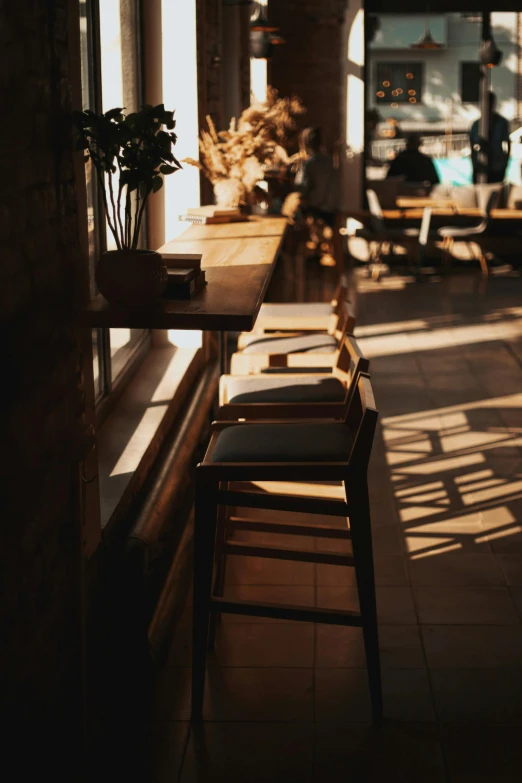 the sun shines through the windows of a restaurant, a portrait, pexels contest winner, light and space, empty stools, morning coffee, late afternoon sun, multiple stories