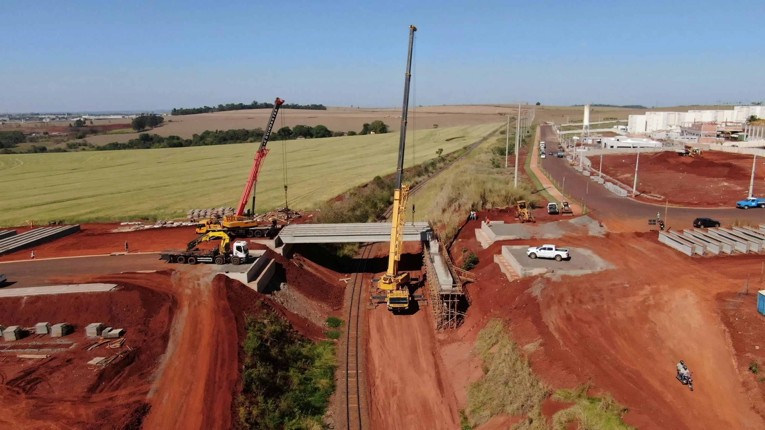 a large crane sitting on top of a dirt field, happening, bridges crossing the gap, brazil, chemrail, avatar image