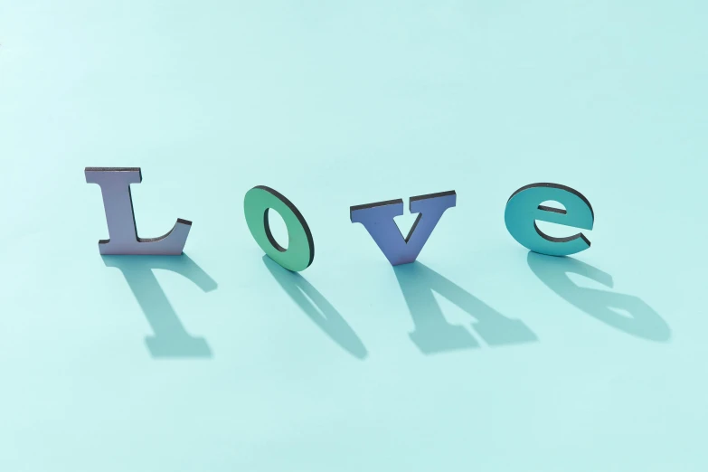 the word love spelled in 3d letters on a blue background, by Rachel Reckitt, trending on pexels, letterism, blue - green tones, pastel palette silhouette, on grey background, enamel