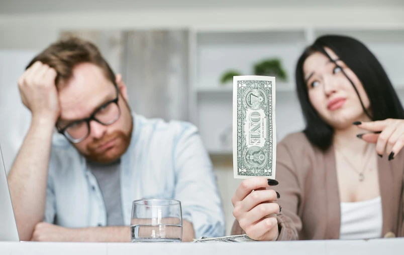 a man and a woman sitting at a table with money in front of them, pexels contest winner, private press, pissed off, slightly minimal, thumbnail, promotional image