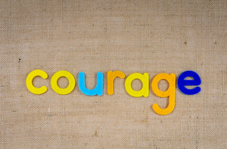 the word courage written in colorful wooden letters, a portrait, by Edward Corbett, trending on pixabay, burlap, avatar image, yellow, hero