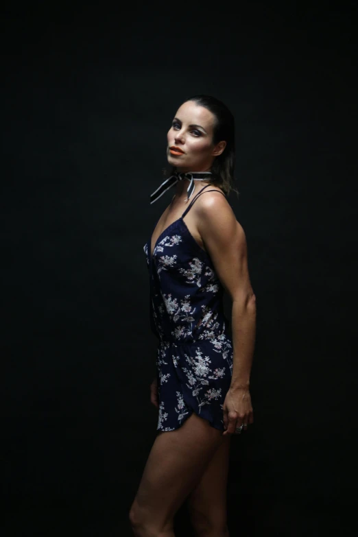 a woman in a short dress posing for a picture, a portrait, by Robbie Trevino, anja millen, profile image, candid!! dark background, wearing a camisole and shorts