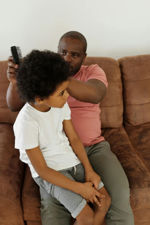 a man and a little boy sitting on a couch, pexels contest winner, incoherents, straight stiff dry damaged hair, afro comb, thumbnail, touching heads