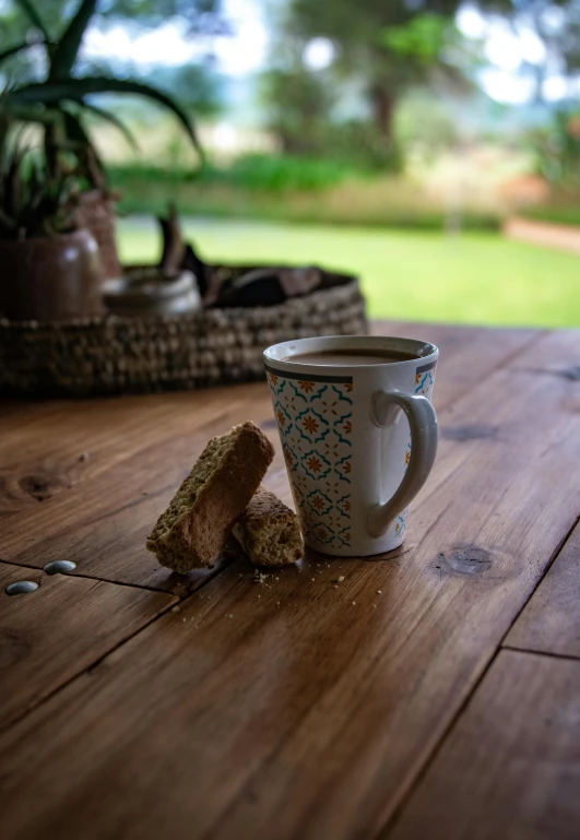 a cup of coffee sitting on top of a wooden table, breakfast at las pozas, detailed product image, moroccan, oak