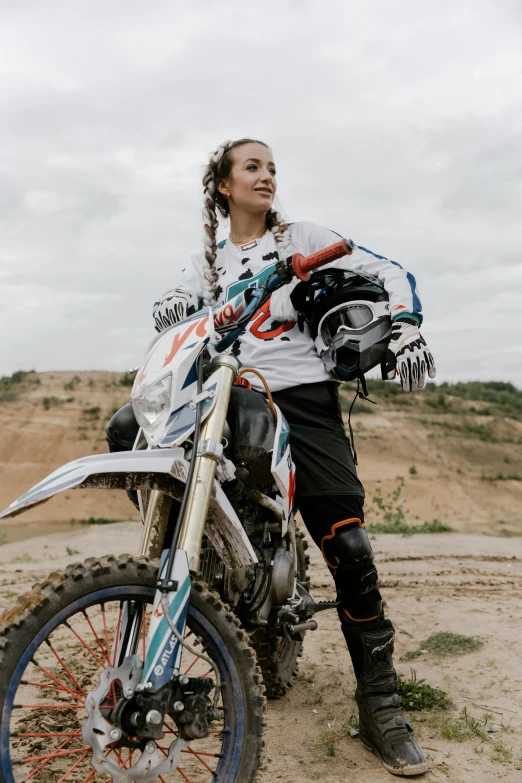 a woman sitting on top of a dirt bike, looking towards the camera, profile image, fourze, gen z