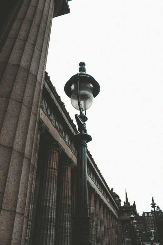 a black and white photo of a street light, a photo, pexels contest winner, tall columns, glasgow, light toned, national gallery