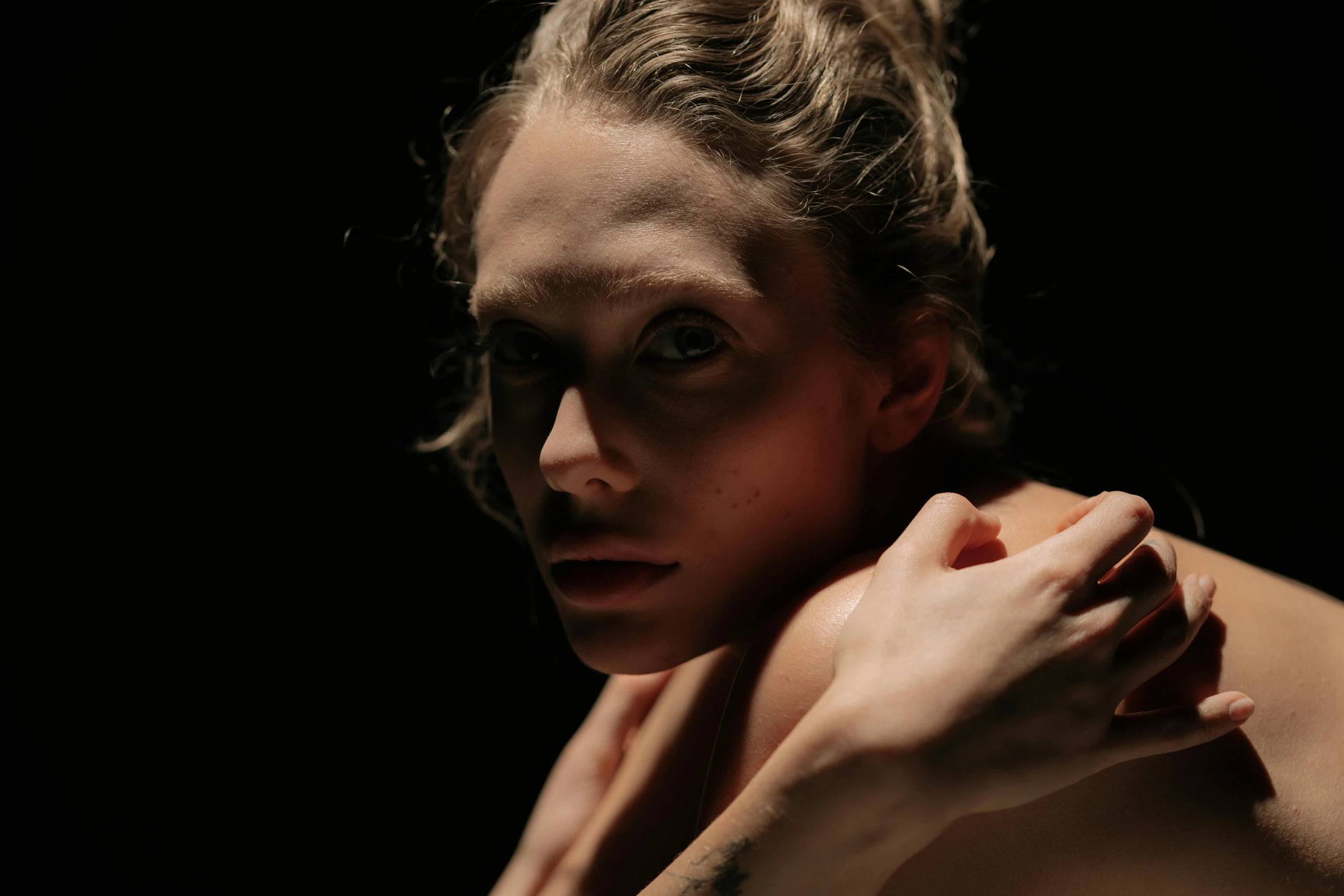 a woman with a tattoo on her arm, a portrait, by Emma Andijewska, pexels contest winner, renaissance, on black paper, still from a music video, reflective skin, looking her shoulder