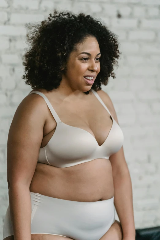 a woman in a white underwear posing for a picture, wearing bra, detailed product image, katey truhn, very large