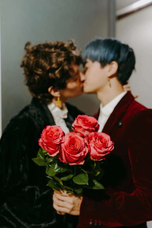 a couple of people that are kissing each other, trending on pexels, draped in velvet and flowers, androgynous person, kpop, roses