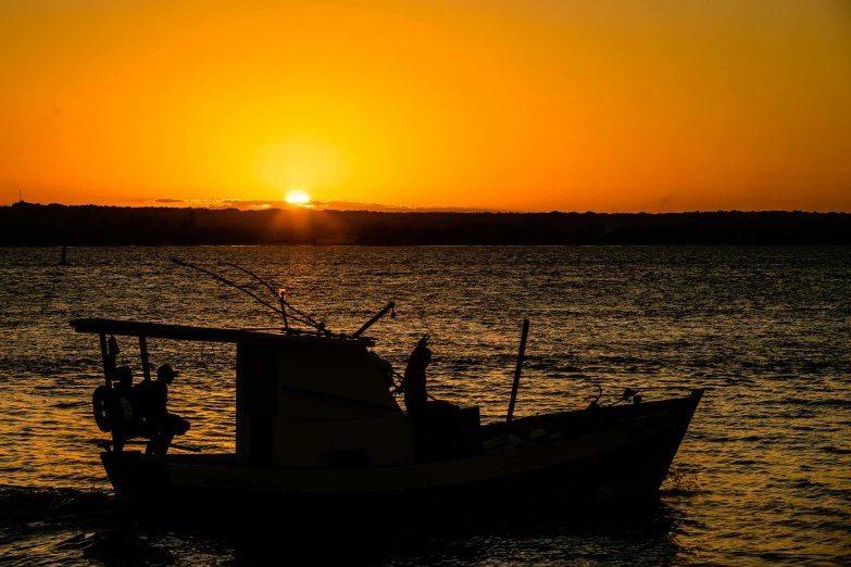 a boat that is sitting in the water, by Peter Churcher, pexels contest winner, silhouette over sunset, fishing, warm glow, manly