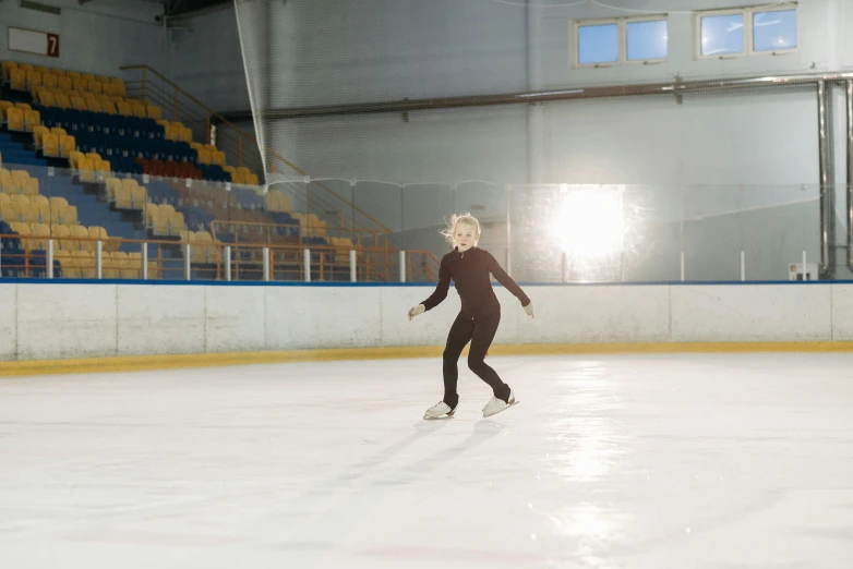 a woman is skating on an ice rink, a portrait, pexels contest winner, arabesque, 15081959 21121991 01012000 4k, wide full body, blond, low quality photo